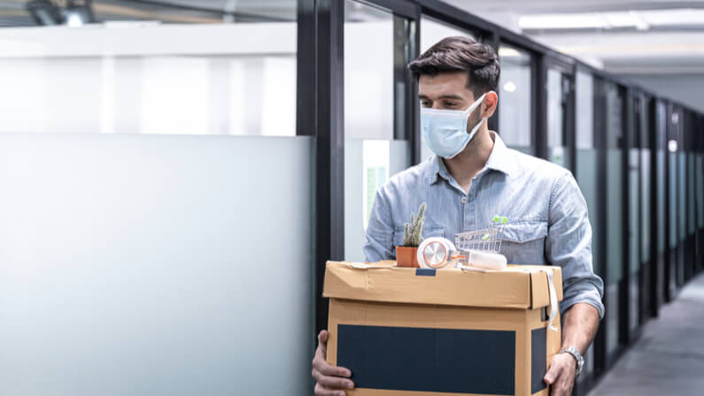 man holding personal box fired from work